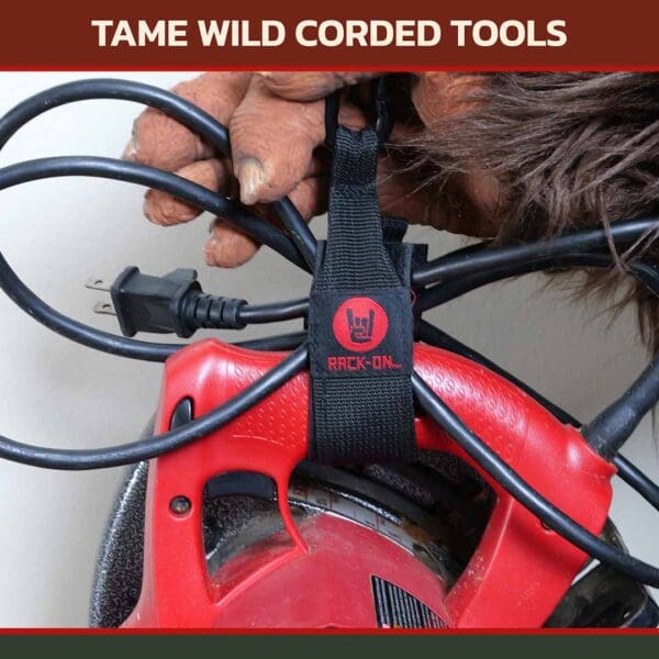 Rack-On_store-images_ACC103-Corded Sasquatch hand holding a RACK-ON Ripper Connector ACC-103 hook and loop storage strap wrapped around a corded power tool.